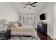 Cozy bedroom offers a calm retreat with large window, dark furniture, and soft textures, complete with ceiling fan at 5258 E Elena Ave, Mesa, AZ 85206