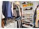 Walk-in closet featuring shelving with shoes, purses and hanging clothes at 5258 E Elena Ave, Mesa, AZ 85206