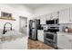 Functional kitchen featuring stainless steel appliances and white cabinets at 5258 E Elena Ave, Mesa, AZ 85206