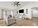 Spacious living room featuring tile floors, a ceiling fan, and natural light at 5258 E Elena Ave, Mesa, AZ 85206