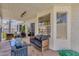 Covered patio with stylish seating, glass fire pit and a view of the pool at 5258 E Elena Ave, Mesa, AZ 85206