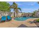 Inviting pool with rock waterfall feature, lush landscaping and relaxing lounge chairs poolside at 5258 E Elena Ave, Mesa, AZ 85206