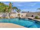 Lush pool area with a rock waterfall, adjacent spa, and plenty of room for entertaining at 5258 E Elena Ave, Mesa, AZ 85206