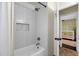 Elegant bathroom showcases a tiled shower with built-in niche, with peek into adjacent bedroom at 5258 E Elena Ave, Mesa, AZ 85206