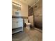 Bathroom featuring a tiled shower with updated vanity and toilet at 5639 N 46Th Ave, Glendale, AZ 85301
