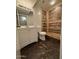 Bathroom featuring a tiled shower with modern vanity and updated toilet at 5639 N 46Th Ave, Glendale, AZ 85301