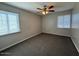 Bedroom with carpet, two windows, ceiling fan and neutral color palette at 5639 N 46Th Ave, Glendale, AZ 85301