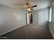 Neutral bedroom features a ceiling fan, closet and access to hallway at 5639 N 46Th Ave, Glendale, AZ 85301