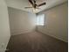 Bedroom with a ceiling fan and a window, with neutral paint and carpeting at 5639 N 46Th Ave, Glendale, AZ 85301