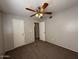 Bedroom featuring neutral walls, carpet flooring, ceiling fan and dual closets at 5639 N 46Th Ave, Glendale, AZ 85301