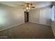 Spacious bedroom with carpet, ceiling fan and two large windows at 5639 N 46Th Ave, Glendale, AZ 85301