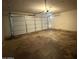 Attached two-car garage with white door and concrete flooring at 5639 N 46Th Ave, Glendale, AZ 85301