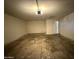 Two-car garage with garage door, concrete floor and lighting at 5639 N 46Th Ave, Glendale, AZ 85301