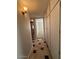 Hallway with decorative flooring, neutral walls, access to bedroom and storage at 5639 N 46Th Ave, Glendale, AZ 85301