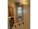 View of hallway with neutral colors and tiled flooring leading to a bathroom at 5639 N 46Th Ave, Glendale, AZ 85301