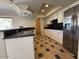 Functional kitchen with white cabinets, granite countertops, stainless steel refrigerator, and tile floor at 5639 N 46Th Ave, Glendale, AZ 85301