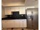 Bright kitchen featuring stainless steel refrigerator, granite countertops, and white cabinetry at 5639 N 46Th Ave, Glendale, AZ 85301