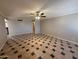 Spacious living room with a ceiling fan and tile flooring in a unique pattern at 5639 N 46Th Ave, Glendale, AZ 85301