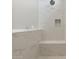 Modern walk-in shower featuring marble-look tile, a built-in bench, and a sleek rainfall shower head at 5832 E Covey Ln, Phoenix, AZ 85054