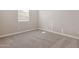Cozy carpeted bedroom illuminated by natural light from a window with neutral paint at 5832 E Covey Ln, Phoenix, AZ 85054