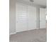 Bedroom closet showcasing large sliding doors, carpeted floor, and neutral-painted walls at 5832 E Covey Ln, Phoenix, AZ 85054