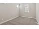 Bright bedroom featuring neutral walls, carpeted floor, and a window with blinds for privacy at 5832 E Covey Ln, Phoenix, AZ 85054