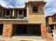 Unfinished new home construction, framed and boarded with open garage and a sunny sky backdrop at 5832 E Covey Ln, Phoenix, AZ 85054