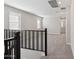 Upstairs hallway with large windows and neutral colored carpet throughout at 5832 E Covey Ln, Phoenix, AZ 85054