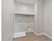 Bright laundry room with wood-look tile flooring, a shelf, and washer/dryer hookups at 5832 E Covey Ln, Phoenix, AZ 85054