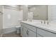 Bathroom with double sink vanity, large mirror, and a shower over tub at 5848 E Covey Ln, Phoenix, AZ 85054