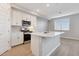Modern kitchen with stainless steel appliances, white cabinetry, and large kitchen island at 5848 E Covey Ln, Phoenix, AZ 85054
