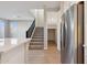 Modern kitchen with stainless steel appliances, island, and open access to carpeted stairs at 5848 E Covey Ln, Phoenix, AZ 85054