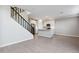 Open floor plan showcasing a modern kitchen and living area with staircase in view at 5848 E Covey Ln, Phoenix, AZ 85054