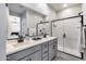 Modern bathroom with double sinks, black fixtures, and glass enclosed shower at 734 E Doral Ave # 202, Gilbert, AZ 85297