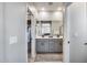 Modern bathroom featuring double vanity, framed mirror, and walk-in closet access at 734 E Doral Ave # 202, Gilbert, AZ 85297