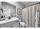 The bathroom features a modern vanity, mirror, tub and shower with decorative shower curtain at 734 E Doral Ave # 202, Gilbert, AZ 85297