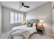 Cozy bedroom featuring plantation shutters, modern lamps, and accent pillows at 734 E Doral Ave # 202, Gilbert, AZ 85297