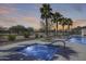 Community pool with a jacuzzi, lounge seating, and well manicured landscaping at 734 E Doral Ave # 202, Gilbert, AZ 85297