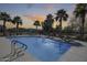 Beautiful community pool surrounded by palm trees and lounge chairs at 734 E Doral Ave # 202, Gilbert, AZ 85297