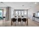 Bright dining area featuring large windows, sleek wood floors, and stylish decor at 734 E Doral Ave # 202, Gilbert, AZ 85297