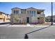Attractive multi-story townhome featuring a balcony, desert landscaping, and convenient street parking at 734 E Doral Ave # 202, Gilbert, AZ 85297