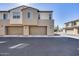 Row of townhomes featuring garages and uniform design with neutral paint and well-kept landscaping at 734 E Doral Ave # 202, Gilbert, AZ 85297