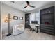Bright home office with modern ceiling fan, plantation shutters, and built-in storage at 734 E Doral Ave # 202, Gilbert, AZ 85297