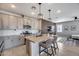 Bright kitchen boasts gray cabinetry, quartz countertops, island with seating, and stainless steel appliances at 734 E Doral Ave # 202, Gilbert, AZ 85297