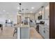 Spacious kitchen featuring gray cabinets, stainless appliances, and a large island with barstool seating at 734 E Doral Ave # 202, Gilbert, AZ 85297
