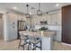 Modern kitchen with stainless steel appliances, a center island, and stylish pendant lighting at 734 E Doral Ave # 202, Gilbert, AZ 85297