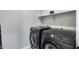 The laundry room features brand new black washer and dryer at 734 E Doral Ave # 202, Gilbert, AZ 85297