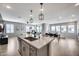 Open-concept kitchen and living area with natural light, kitchen island seating, and dining space at 734 E Doral Ave # 202, Gilbert, AZ 85297