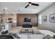 Open concept living room with a modern kitchen, wood accent wall, and comfortable seating area at 734 E Doral Ave # 202, Gilbert, AZ 85297