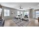 Bright living room features a white sectional sofa, geometric rug, and natural light through shuttered windows at 734 E Doral Ave # 202, Gilbert, AZ 85297